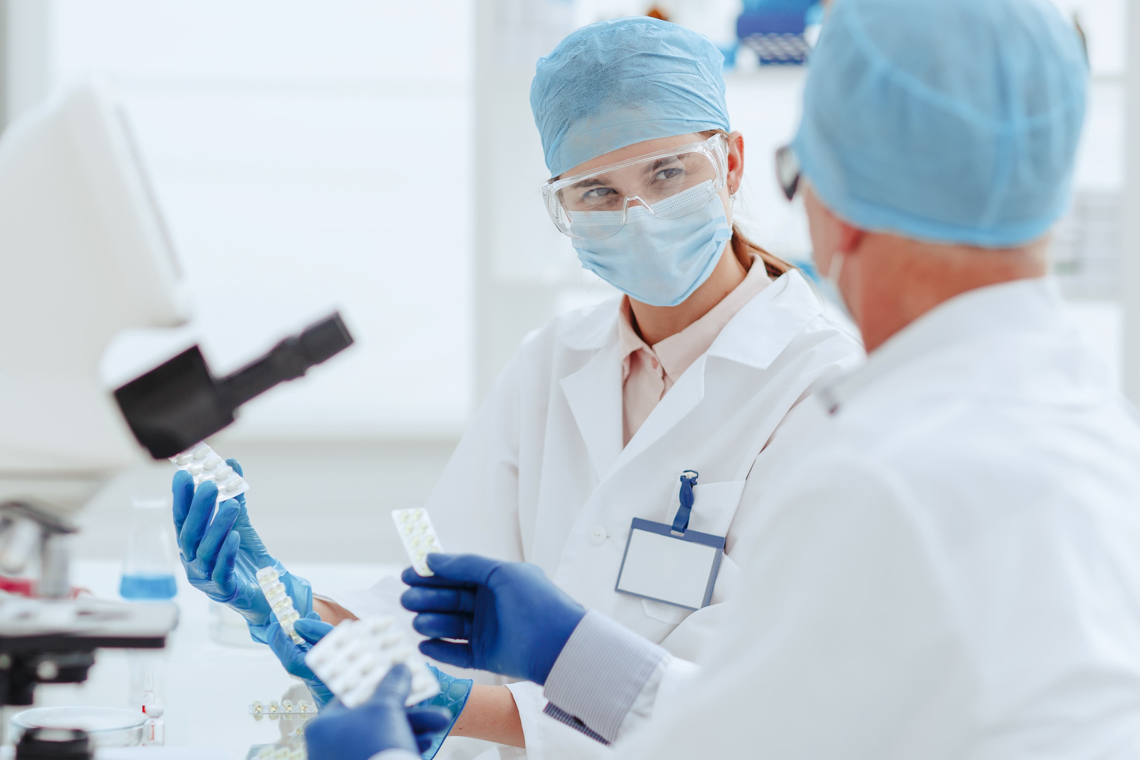 two doctors looking at each other while sorting medication